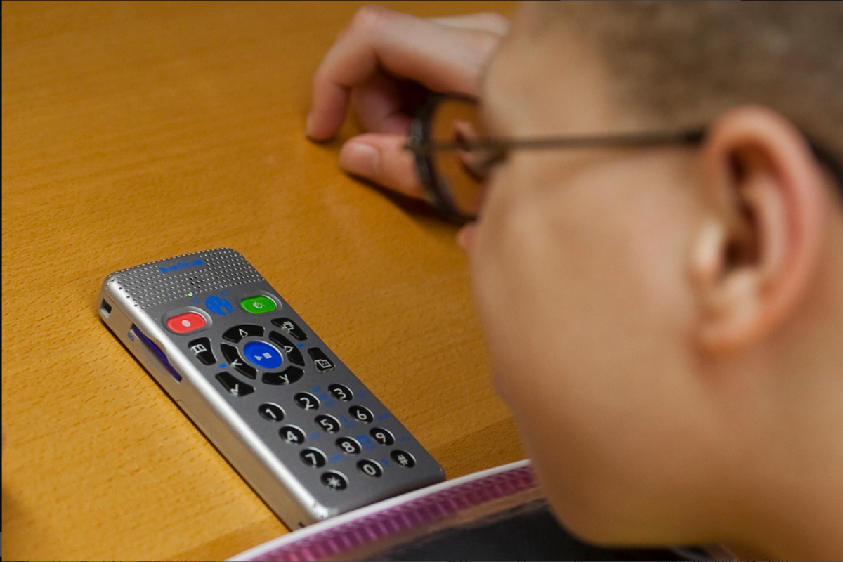 A boy uses a Book Port Plus from APH