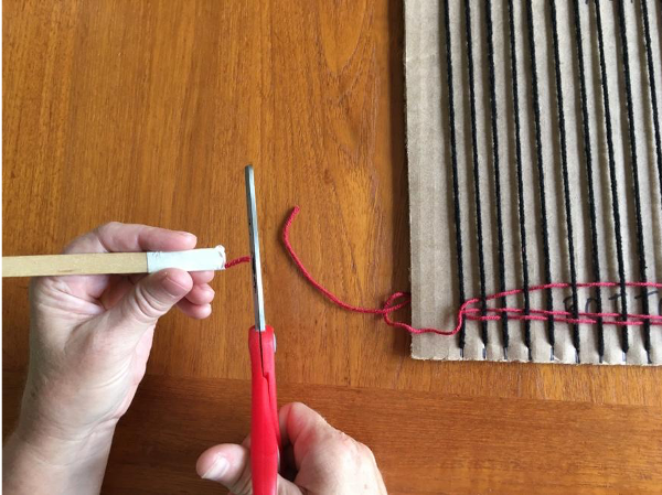 Clipping the shed stick from the first color of yarn