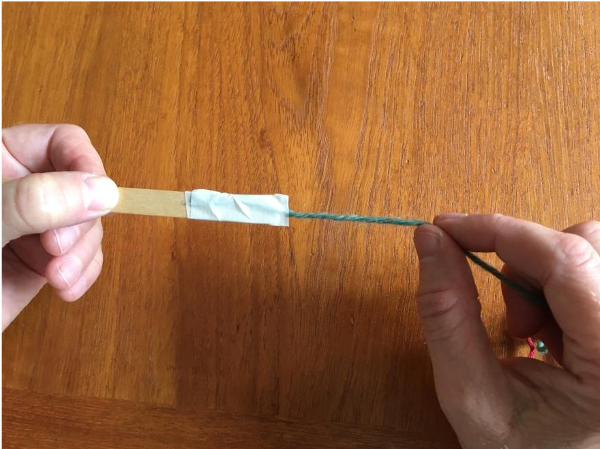 Wrapping masking tape around shed stick