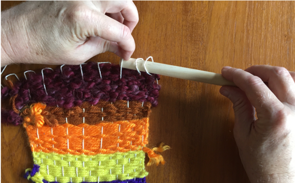 Inserting dowel through loops