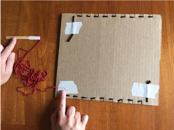 Taping yarn to back of loom