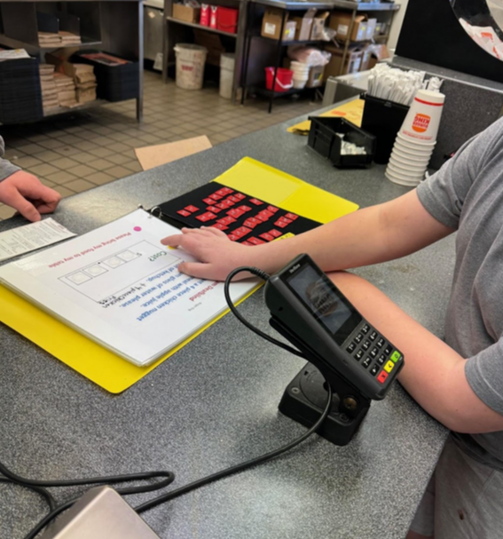 Liam using the low tech restaurant book