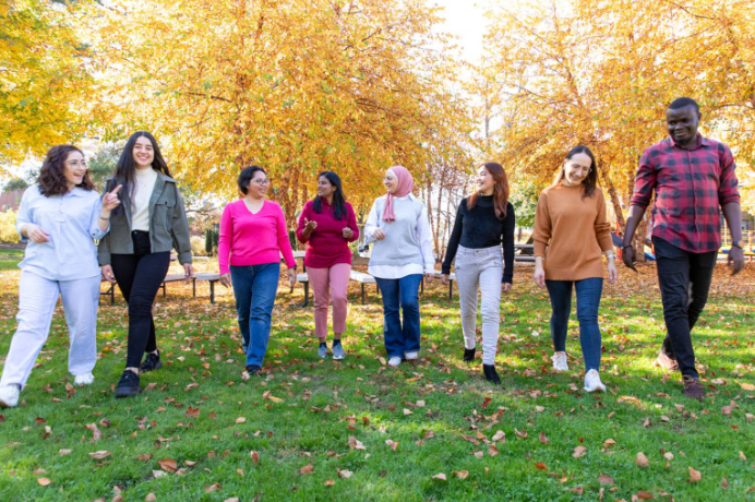 Eight individuals in the program walking the grounds of Perkins. 